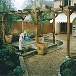Pergola, pond and raised borders